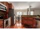 A kitchen featuring stainless steel appliances, stone countertops, and hardwood flooring leading to the dining area at 7562 Sedgebrook W Dr, Stanley, NC 28164