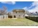 The back of this home includes a patio with sliding doors and a fenced backyard at 8247 Pozzi Rd, Charlotte, NC 28216