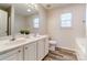 Bathroom featuring double sinks, large vanity mirror, and natural light from the window at 8247 Pozzi Rd, Charlotte, NC 28216