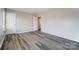 Bedroom with an open door and closet, featuring attractive flooring and ample space at 8247 Pozzi Rd, Charlotte, NC 28216