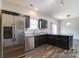 Spacious kitchen with stainless steel appliances, dark cabinets, and an island at 8247 Pozzi Rd, Charlotte, NC 28216