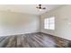 Inviting living room featuring a ceiling fan, large window, and beautiful flooring at 8247 Pozzi Rd, Charlotte, NC 28216