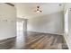 Bright living room with ceiling fan, modern light fixture and sliding glass doors to the back yard at 8247 Pozzi Rd, Charlotte, NC 28216