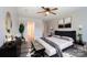 Luxurious main bedroom with a decorative ceiling fan, stylish decor, and ample natural light at 8247 Pozzi Rd, Charlotte, NC 28216