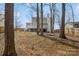 Large backyard with privacy fence, mature trees, and a home with a deck in the background at 9613 Central Dr, Mint Hill, NC 28227