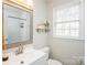 Well-lit bathroom with white subway tile, decorative shelves, and a modern vanity at 9613 Central Dr, Mint Hill, NC 28227