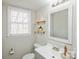 Well-lit bathroom features a vanity, mirror, and modern fixtures at 9613 Central Dr, Mint Hill, NC 28227