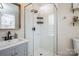 Modern bathroom features a glass-enclosed shower with gray vanity and sleek black fixtures at 9613 Central Dr, Mint Hill, NC 28227