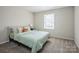 Inviting bedroom featuring neutral colors, a large window, and plush carpeting at 9613 Central Dr, Mint Hill, NC 28227