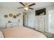 Comfortable bedroom featuring a ceiling fan, closet, dresser, and television for easy viewing at 9613 Central Dr, Mint Hill, NC 28227