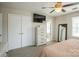 This cozy bedroom includes a television, closet, full-length mirror, and natural light at 9613 Central Dr, Mint Hill, NC 28227