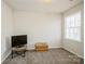 Neutral carpeted bedroom with a window allowing natural light and a television on a small stand at 9613 Central Dr, Mint Hill, NC 28227