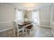 Bright dining room features an elegant chandelier and a wooden table with bench seating at 9613 Central Dr, Mint Hill, NC 28227