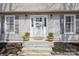 Inviting front entrance with decorative plants and a charming wreath at 9613 Central Dr, Mint Hill, NC 28227