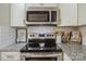 Close-up of stainless steel oven and microwave with granite countertops at 9613 Central Dr, Mint Hill, NC 28227