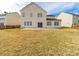 Back exterior of a two-story home with a well-sized backyard and a sliding glass door at 9684 Ravenscroft Nw Ln, Concord, NC 28027