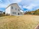 View of the home's rear, with a large backyard space, concrete patio and privacy fence at 9684 Ravenscroft Nw Ln, Concord, NC 28027