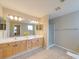 Bright bathroom features double sinks, vanity with lots of cabinets, and glass shower at 9684 Ravenscroft Nw Ln, Concord, NC 28027