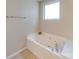 A close-up of the soaking bathtub in a bright bathroom, adding a touch of relaxation to the home at 9684 Ravenscroft Nw Ln, Concord, NC 28027