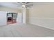 Comfortable bedroom with a ceiling fan and doorway to a living area with fireplace at 9684 Ravenscroft Nw Ln, Concord, NC 28027