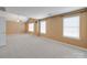 Spacious carpeted bedroom with a vaulted ceiling and two large windows at 9684 Ravenscroft Nw Ln, Concord, NC 28027