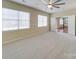 Light-filled bedroom featuring a ceiling fan and access to another room at 9684 Ravenscroft Nw Ln, Concord, NC 28027