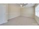 Spacious bedroom features a ceiling fan, neutral carpeting, and ample natural light at 9684 Ravenscroft Nw Ln, Concord, NC 28027