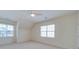 Neutral-toned bedroom featuring two windows for natural light and a ceiling fan for added comfort at 9684 Ravenscroft Nw Ln, Concord, NC 28027