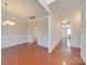 Spacious dining room showcasing hardwood floors, chair rail, and traditional lighting at 9684 Ravenscroft Nw Ln, Concord, NC 28027