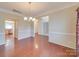 Elegant dining area features hardwood floors, chandelier, and is conveniently located near the kitchen at 9684 Ravenscroft Nw Ln, Concord, NC 28027