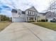 Charming two-story home featuring a covered front porch and a spacious two car garage at 9684 Ravenscroft Nw Ln, Concord, NC 28027