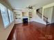 Bright living room with hardwood floors, fireplace, and built-in shelving at 9684 Ravenscroft Nw Ln, Concord, NC 28027