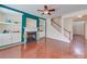 Cozy living room with a fireplace, built-in shelving, and staircase that leads to the upper level at 9684 Ravenscroft Nw Ln, Concord, NC 28027