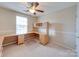 Home office with a built-in desk, cabinets, and a window, providing a functional workspace at 9684 Ravenscroft Nw Ln, Concord, NC 28027