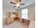 Bright home office featuring a built-in desk, cabinets, and a window, enhancing productivity and organization at 9684 Ravenscroft Nw Ln, Concord, NC 28027