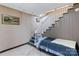 A basement with a staircase and a bed with a checkered pattern and wall decor at 1109 Hemlock Dr, Shelby, NC 28150