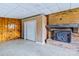 Basement with decorative fireplace with brick surround and painted wood paneling at 1109 Hemlock Dr, Shelby, NC 28150