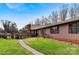 Ranch-style home with a brick chimney, shutters, and grass yard at 1109 Hemlock Dr, Shelby, NC 28150