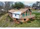 Charming split-level home featuring a spacious deck and large windows, set in a lush, wooded landscape at 1109 Hemlock Dr, Shelby, NC 28150