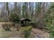 Gazebo in wooded area with overgrown landscaping and picnic table at 1109 Hemlock Dr, Shelby, NC 28150