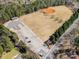 Aerial view of a baseball field and soccer field with parking lot surrounded by trees at 11122 Windgate Ct, Tega Cay, SC 29708