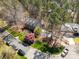 An aerial view of a two-story brick home with mature landscaping and neighborhood street at 11122 Windgate Ct, Tega Cay, SC 29708