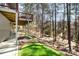 Expansive backyard with lush lawn, mature trees, and a deck overlooking the serene landscape at 11122 Windgate Ct, Tega Cay, SC 29708