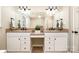 Spacious bathroom with double vanity featuring granite countertops, framed mirrors, and modern lighting fixtures at 11122 Windgate Ct, Tega Cay, SC 29708