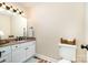 Cozy half bathroom featuring vanity with granite countertop, framed mirror, and a standard toilet at 11122 Windgate Ct, Tega Cay, SC 29708