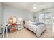 Bright bedroom featuring carpet, natural light, a ceiling fan, and a simple white metal frame bed at 11122 Windgate Ct, Tega Cay, SC 29708