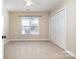 Clean bedroom featuring carpet, natural light, and a double door closet for ample storage at 11122 Windgate Ct, Tega Cay, SC 29708