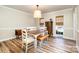 Bright dining room featuring hardwood floors, neutral walls, and wooden table with bench at 11122 Windgate Ct, Tega Cay, SC 29708