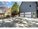 Spacious driveway leading to a two-car garage with steps up to the landscaped yard at 11122 Windgate Ct, Tega Cay, SC 29708