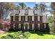 Charming two-story brick home with manicured lawn, black shutters, and a welcoming front door at 11122 Windgate Ct, Tega Cay, SC 29708